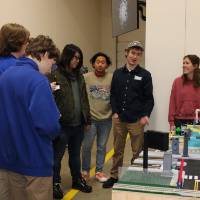 people standing around a senior project